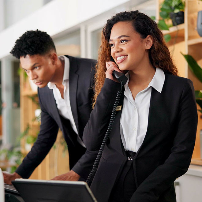 Hotel staff at a reception desk